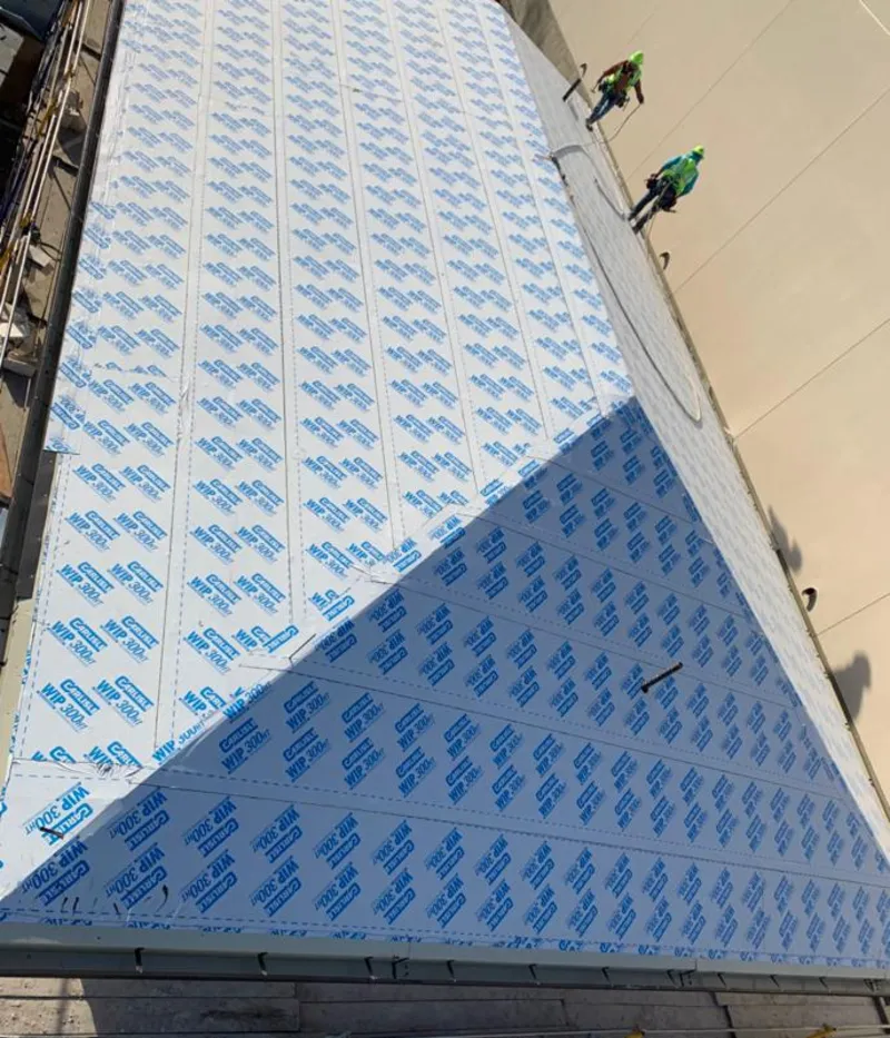 Professional roofers installing underlayment on a metal roof in Victorville